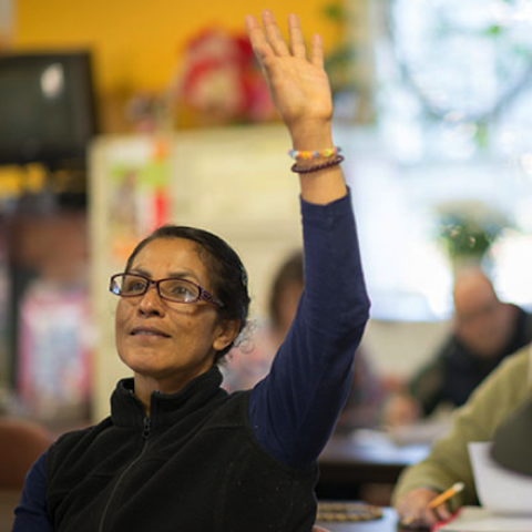 Woman raising hand to ask question